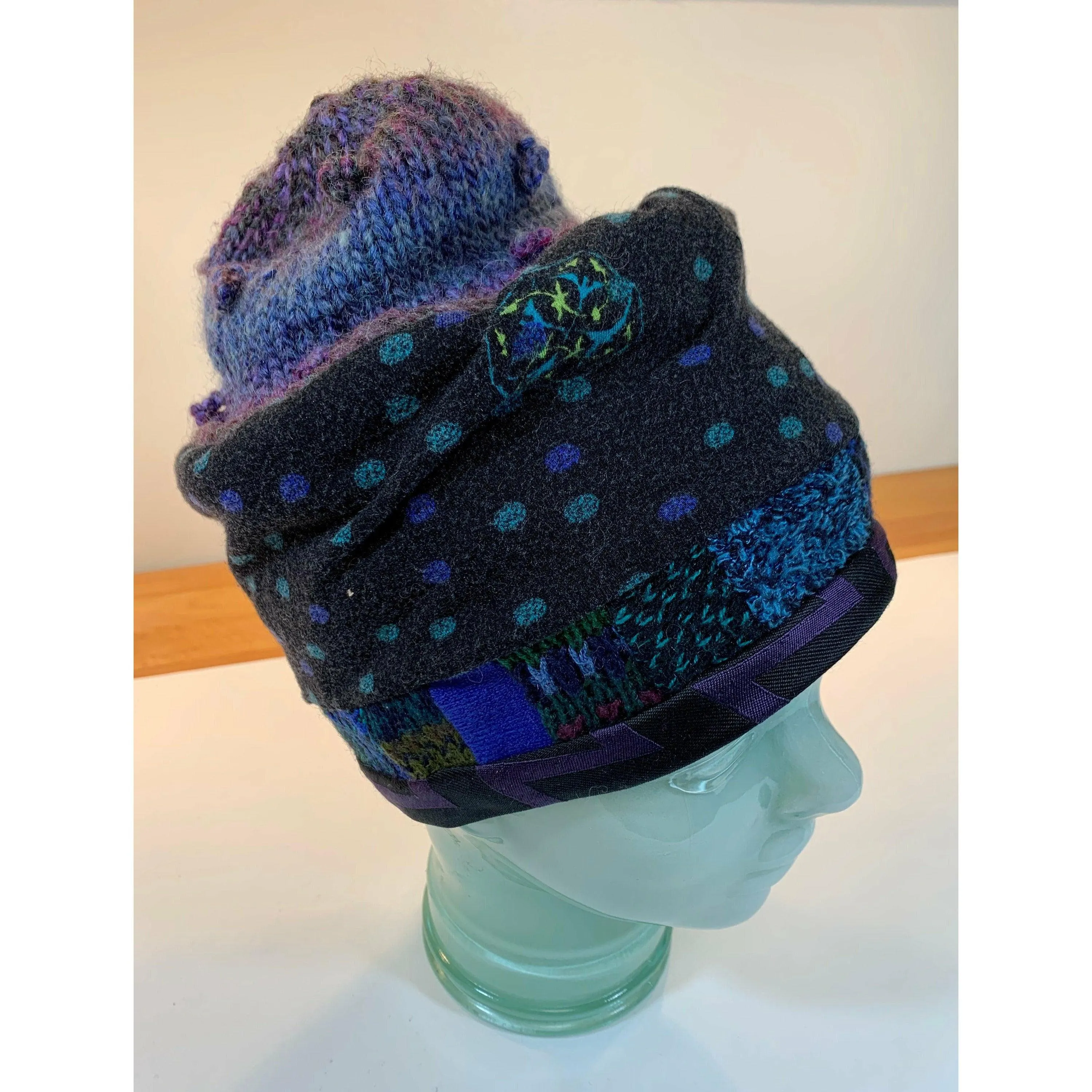 Soft cozy black and blue winter hat from repurposed and hand - knitted yarns with a silk neck tie brim.