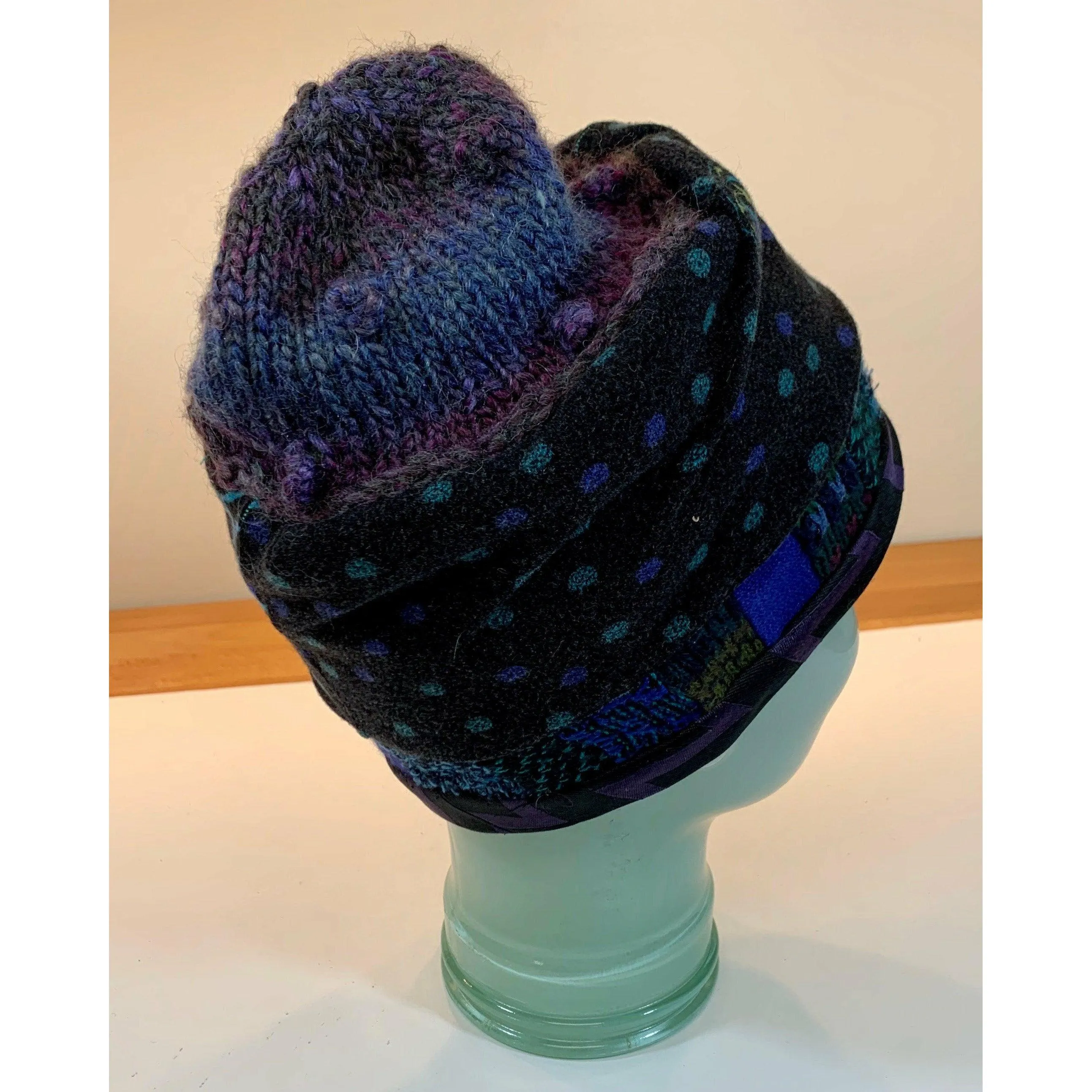 Soft cozy black and blue winter hat from repurposed and hand - knitted yarns with a silk neck tie brim.