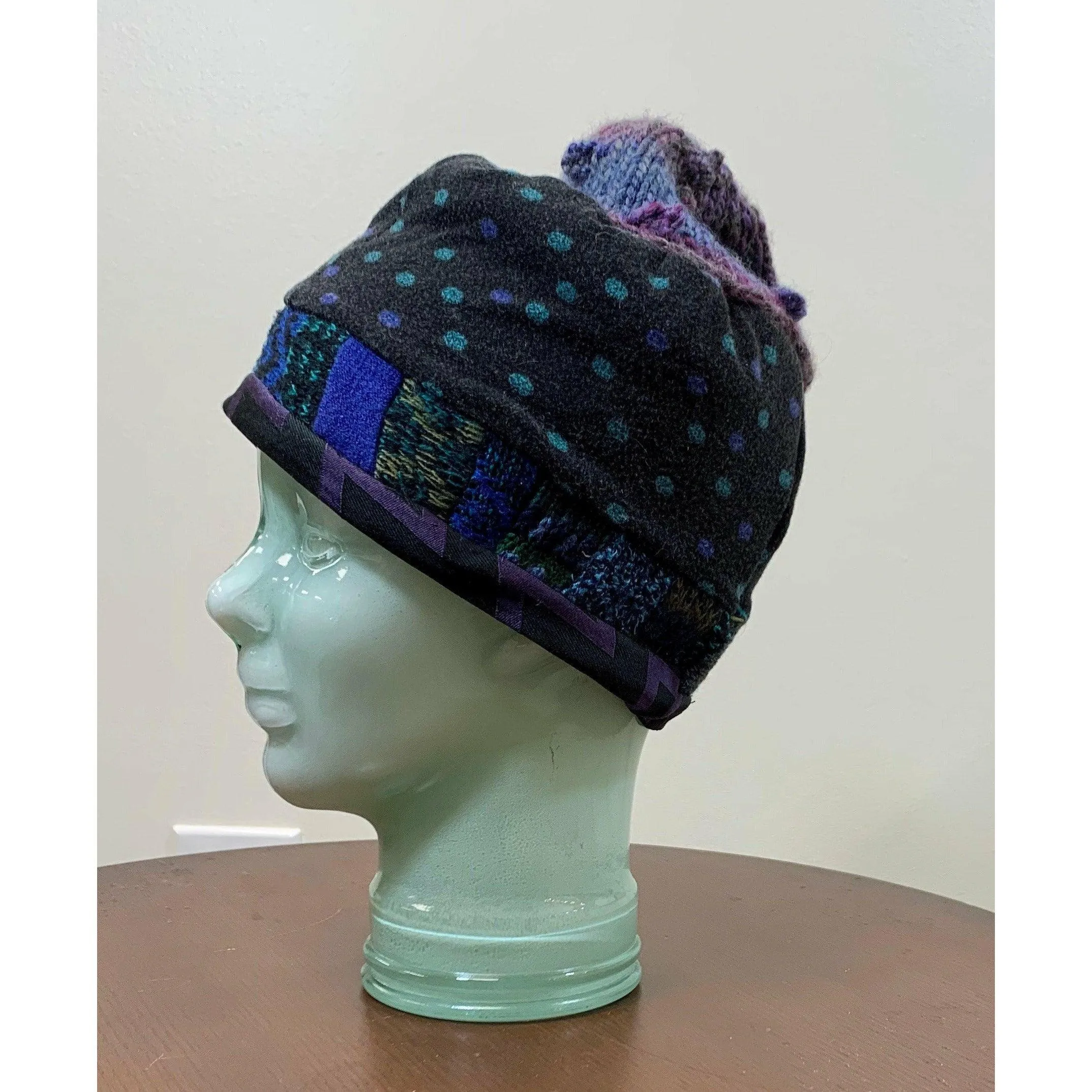 Soft cozy black and blue winter hat from repurposed and hand - knitted yarns with a silk neck tie brim.