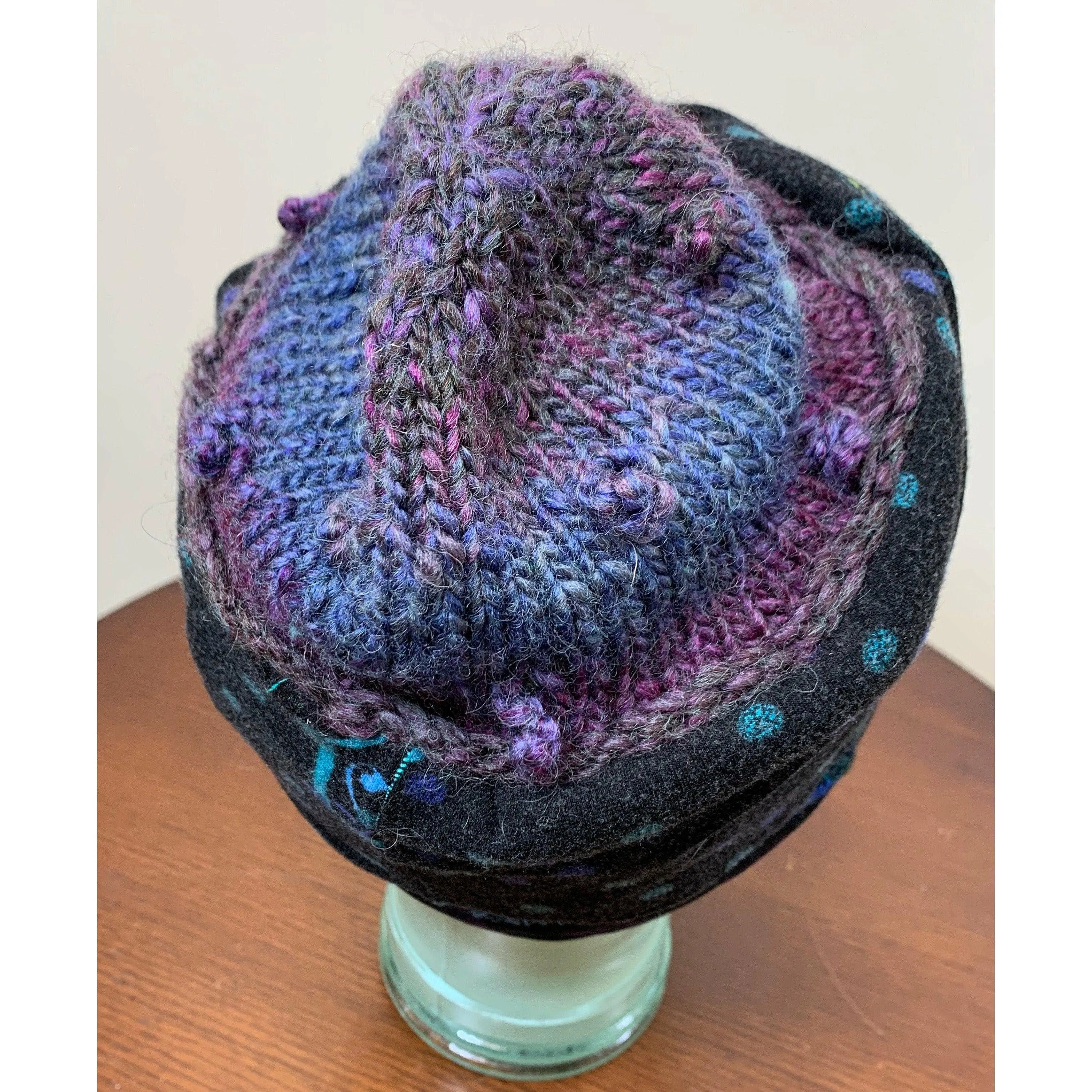 Soft cozy black and blue winter hat from repurposed and hand - knitted yarns with a silk neck tie brim.